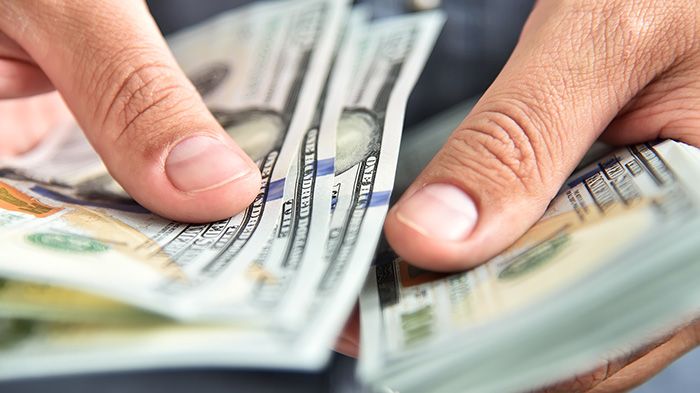 Financal Readiness_Close up of businessman counts money in hands_small.jpg